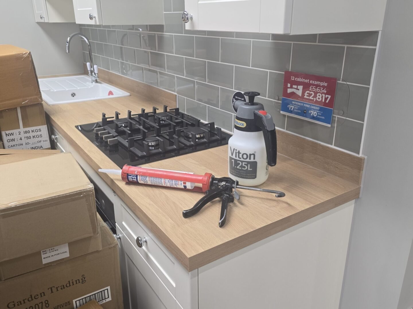 Professional mastic man in bath offering quality silicone sealant on a kitchen for one of our customer