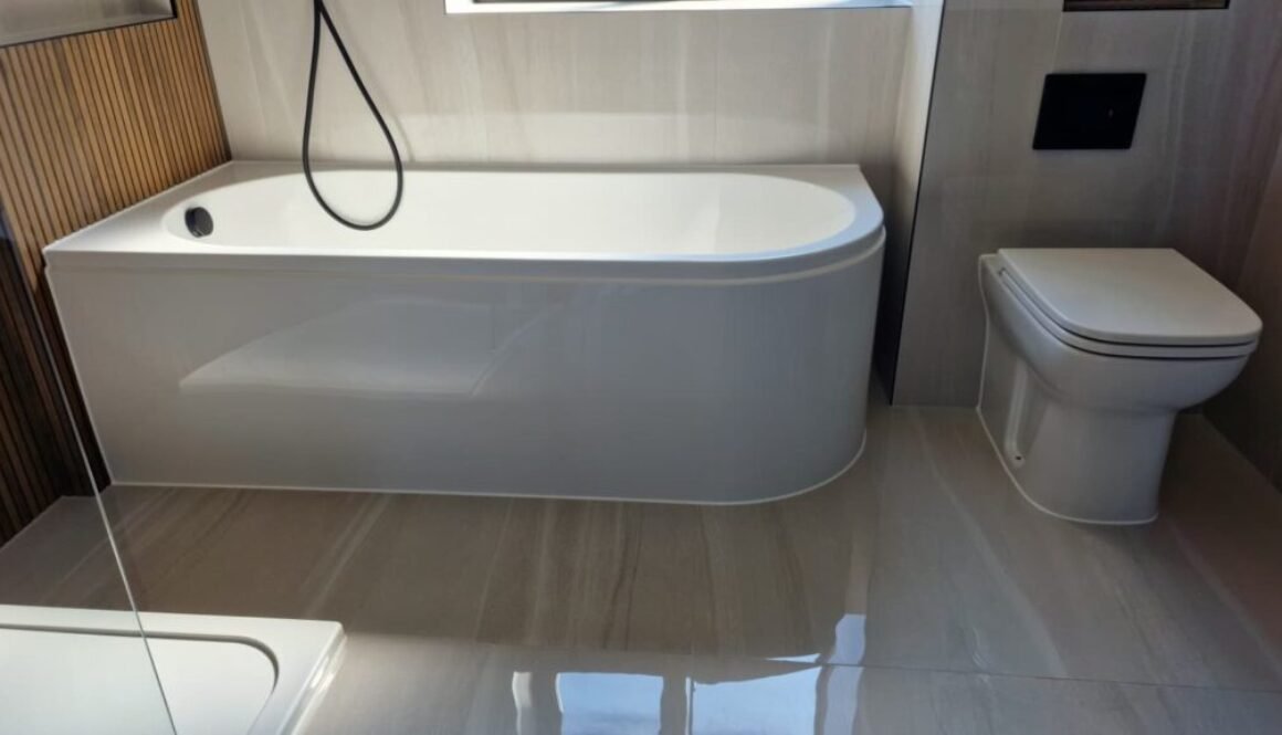 Neat silicone sealant finish around bathroom bath in Dorchester property